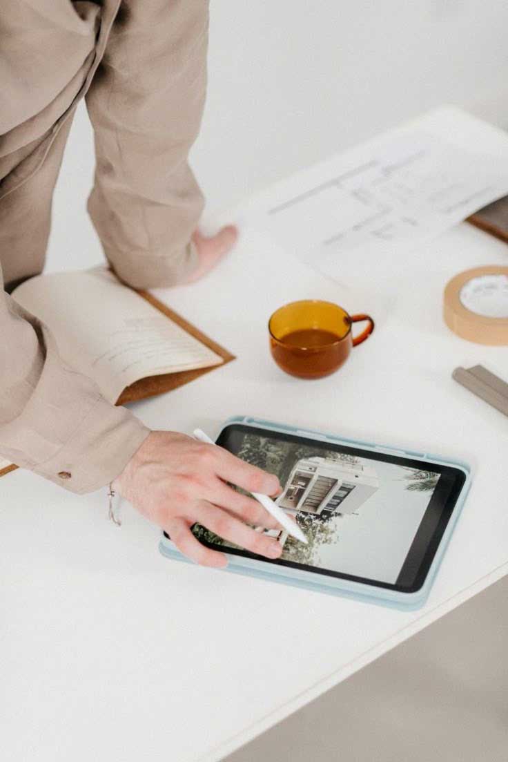 10 Reasons to Hire Me as Your Personal Brand Photographer 5 personal brand photo showing a local architect looking at a house render